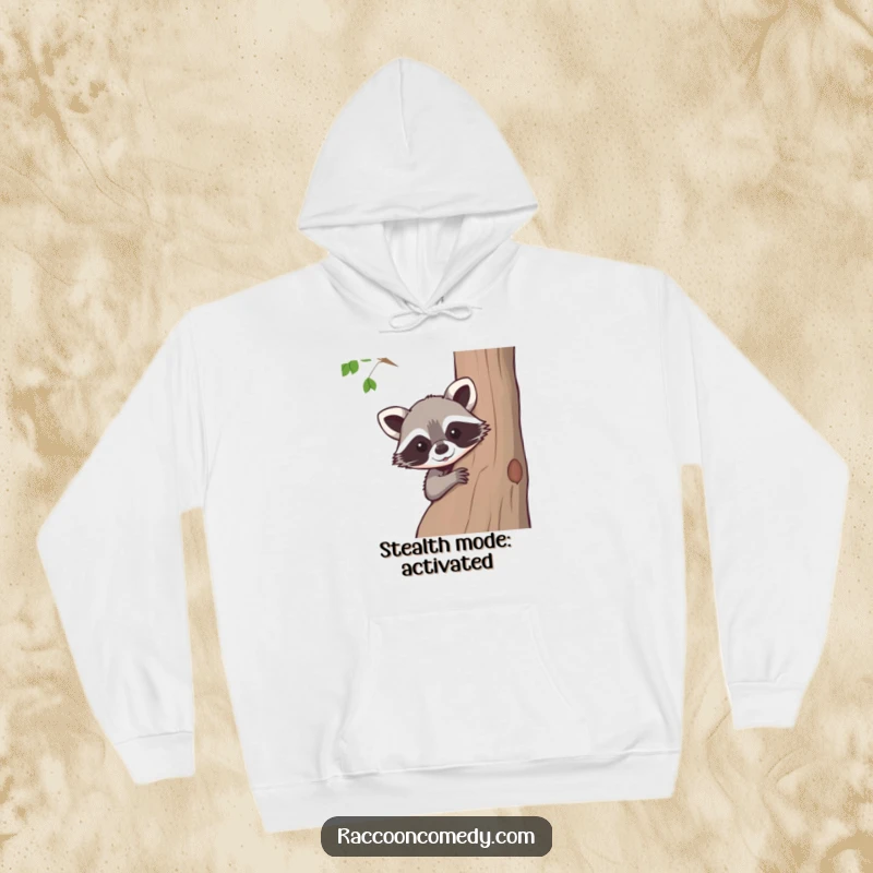 Funny raccoon hoodie, cozy and warm, a cute raccoon peeking from behind a tree, perfect for chilly days and laughs.