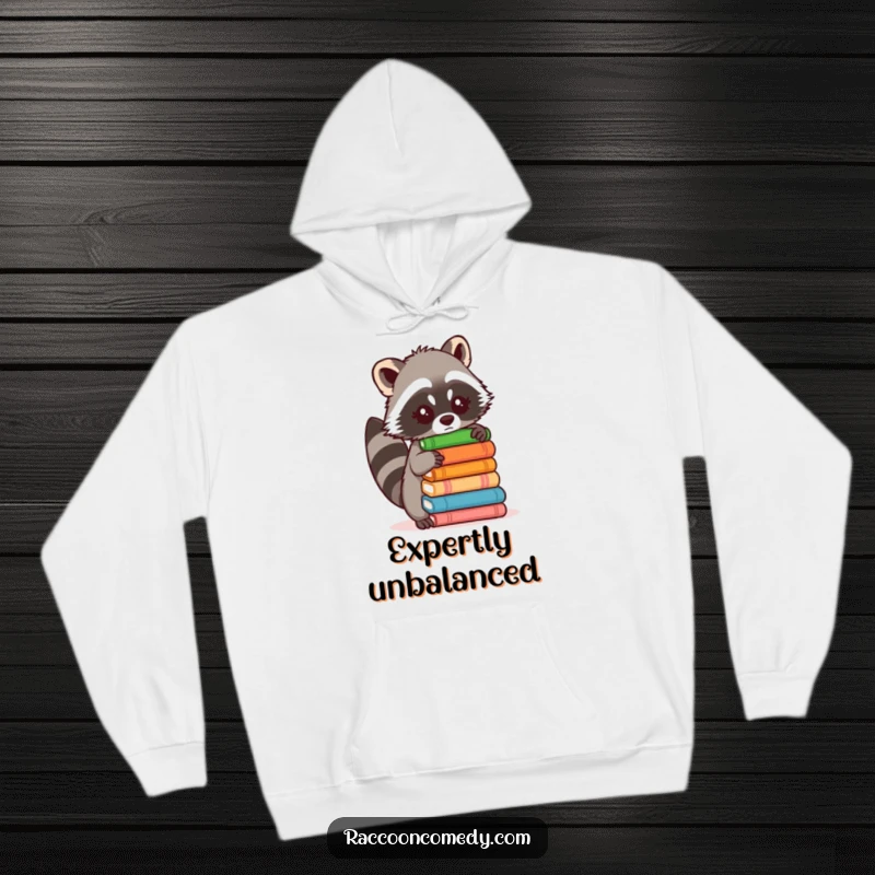 Funny hoodie with a cute raccoon trying to balance a precarious stack of objects, capturing a moment of comical challenge.