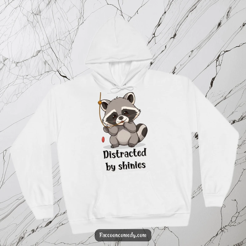 Funny kawaii raccoon hoodie, engrossed in playfully batting at a dangling string with sheer delight.