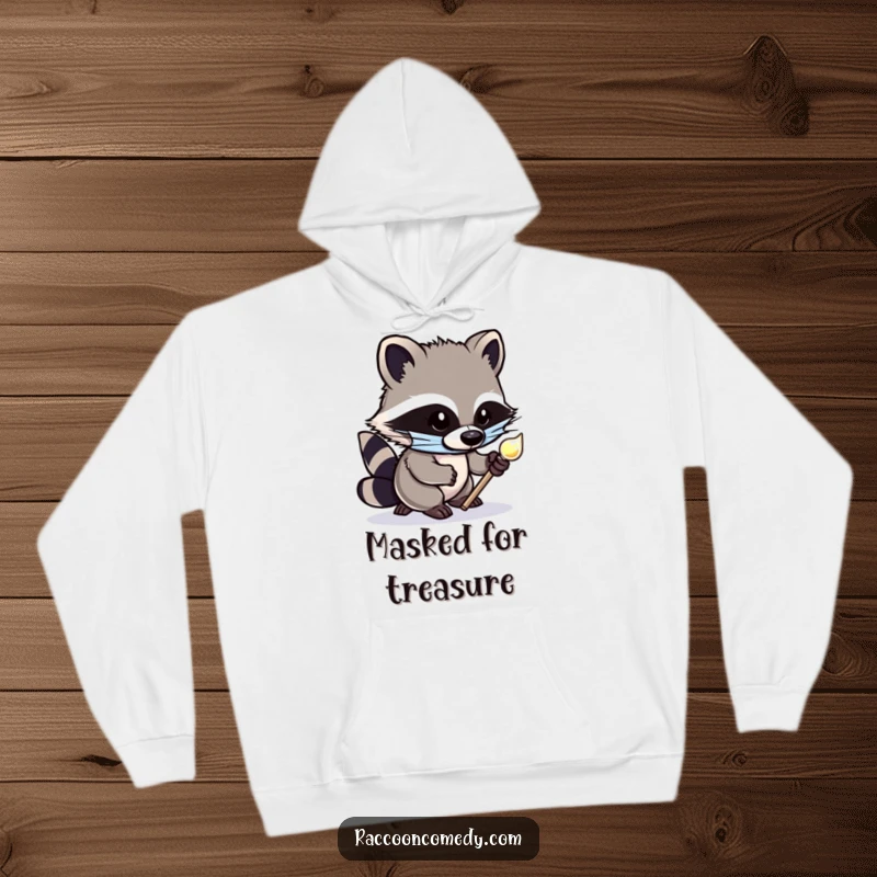 Funny hoodie depicting a cute, masked raccoon tiptoeing stealthily with a shiny object, offering warmth and a humorous, mischievous vibe.
