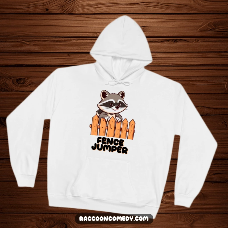 Funny hoodie showing a sly raccoon with a grin scaling a stylized fence, providing warmth and a touch of playful daring.
