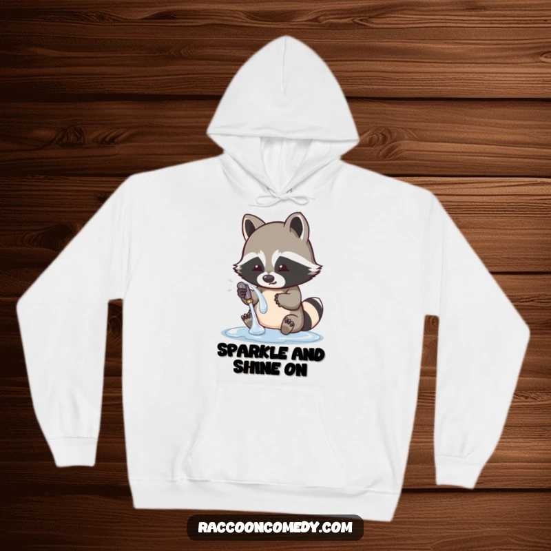 Funny raccoon hoodie depicting a cute character playfully washing a shiny object, offering comfort and a touch of bandit humor.