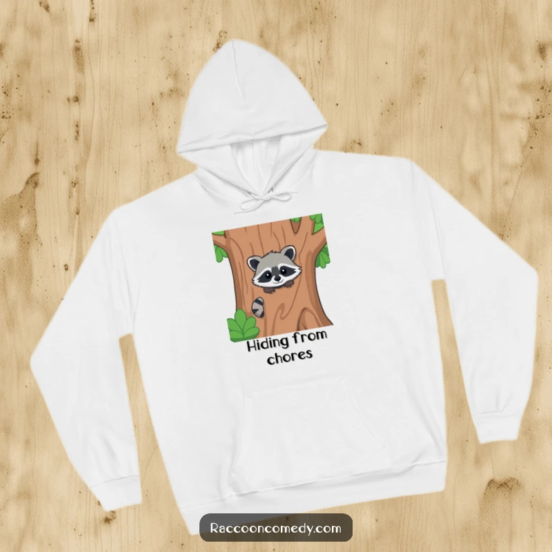 Funny kawaii raccoon hoodie, peeking from behind a large stylized tree, ready for a secret forest adventure.