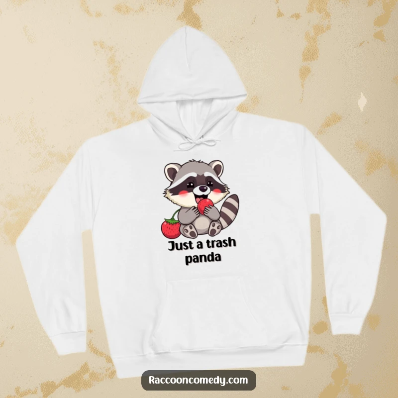 Funny raccoon hoodie featuring a contented character happily devouring a large, sweet berry, perfect for cozy, humorous moments.