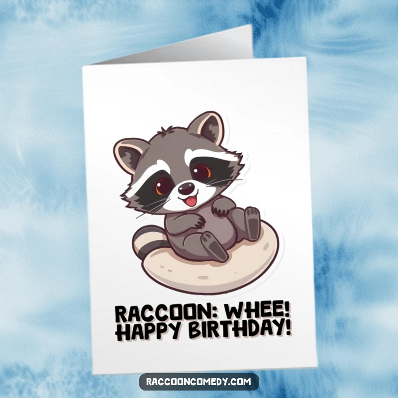 Funny Free Printable Birthday Card: Glee-filled raccoon sliding down a smooth surface, spreading birthday cheer.