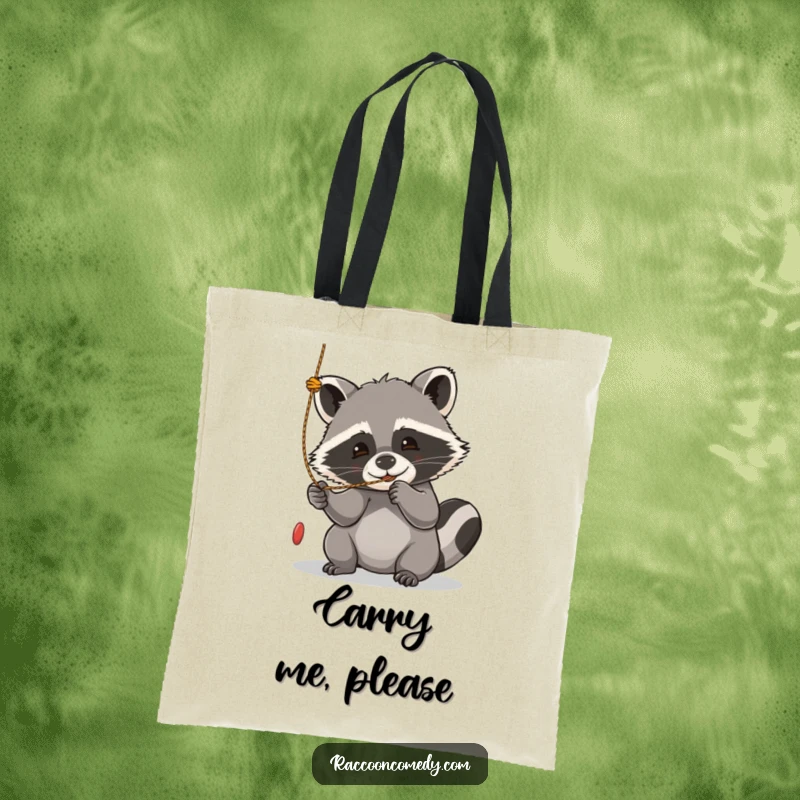 Funny kawaii raccoon tote bag, captured mid-play, batting enthusiastically at a dangling string.