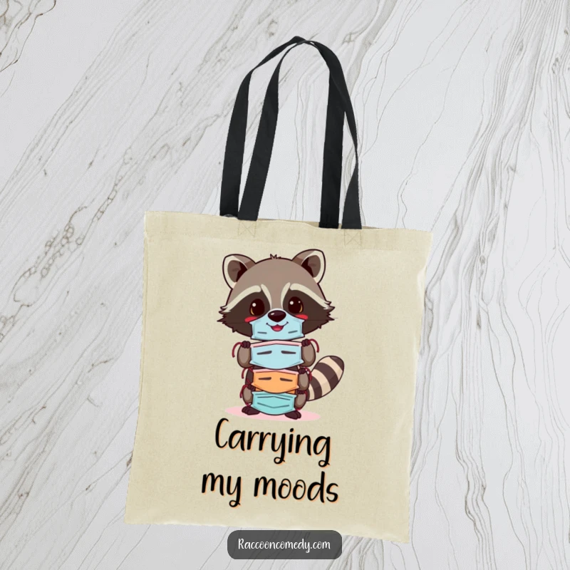 Funny raccoon tote bag featuring a cheerful raccoon balancing a stack of colorful masks, perfect for carrying daily essentials with humor and style.