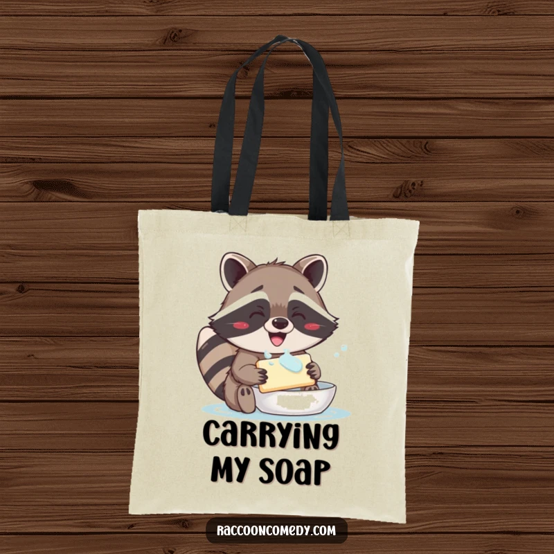 Funny tote bag printed with a cheerful raccoon, sporting a big grin while enthusiastically washing a bar of soap.